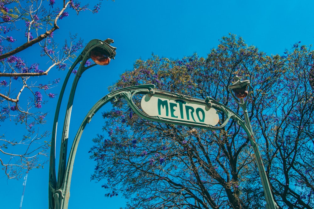 a street sign is hanging from a lamp post