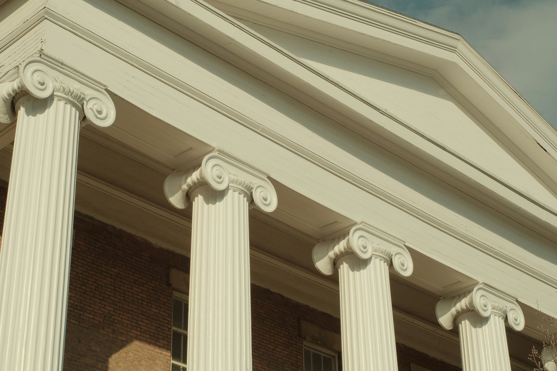 a close up of a building with columns and a clock