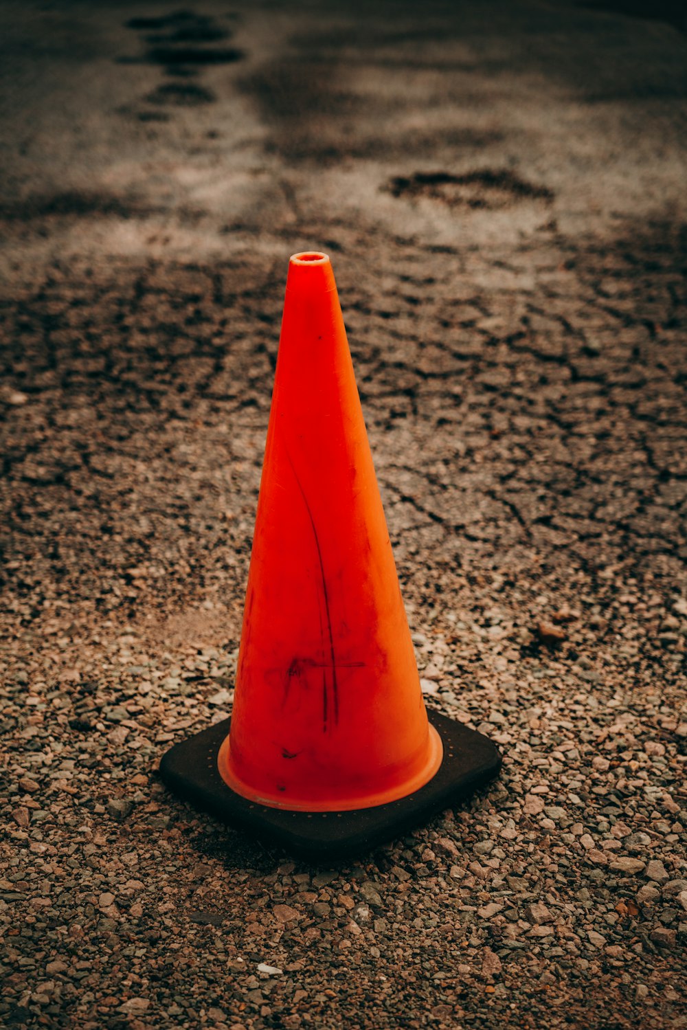 an orange traffic cone sitting on the ground