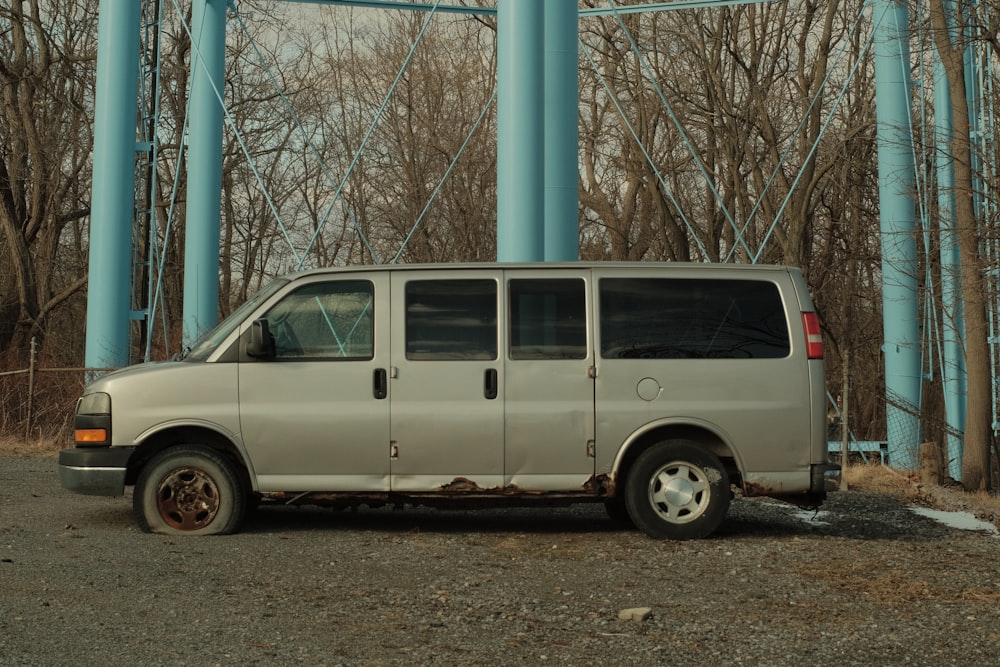 a van parked in front of a blue pillar