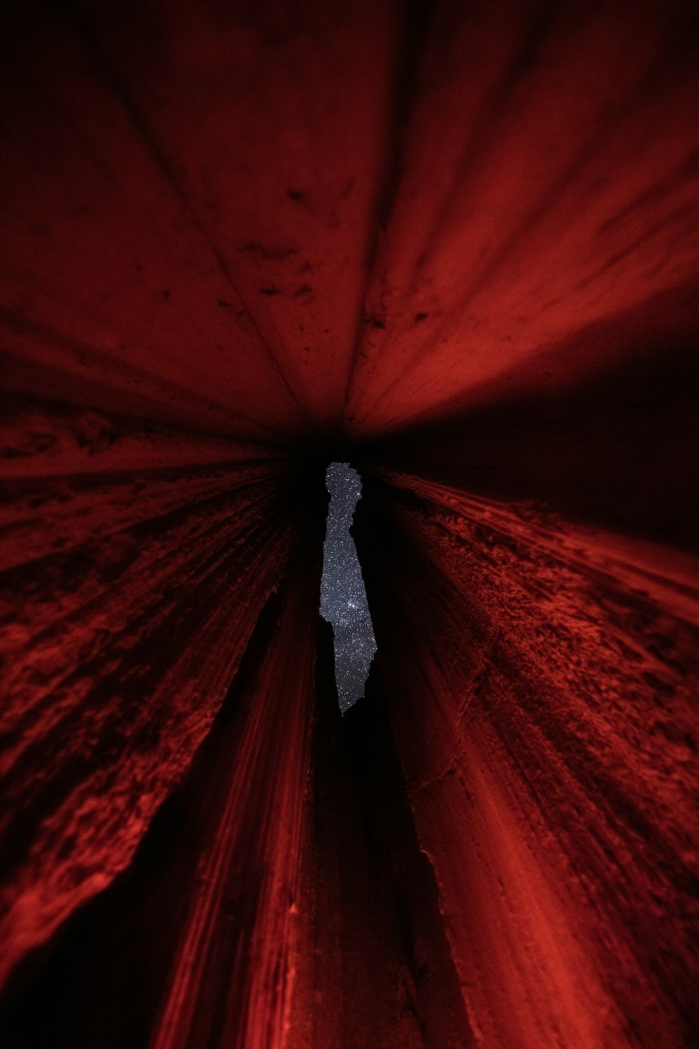 a person standing in the middle of a tunnel