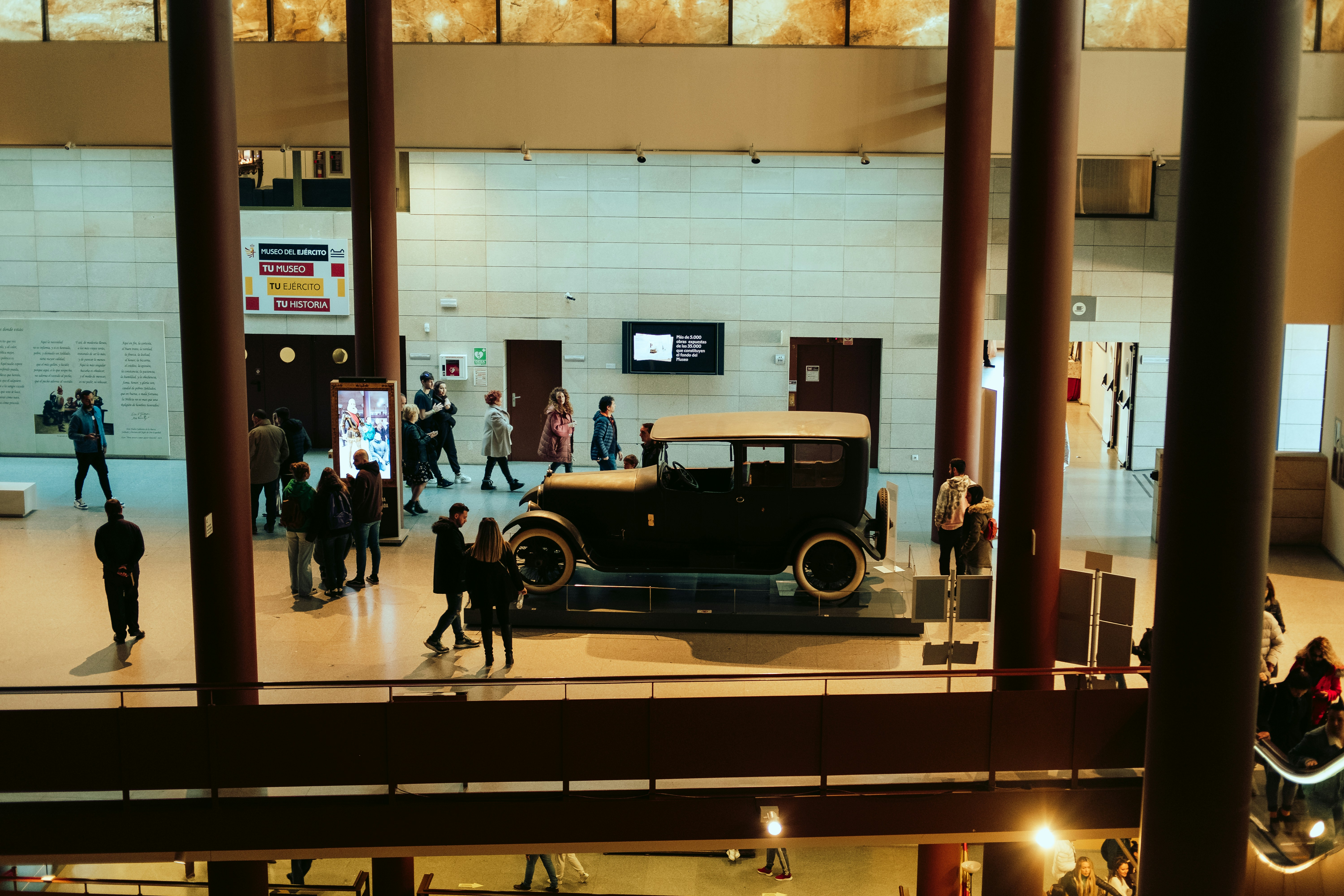a group of people standing around a car in a building