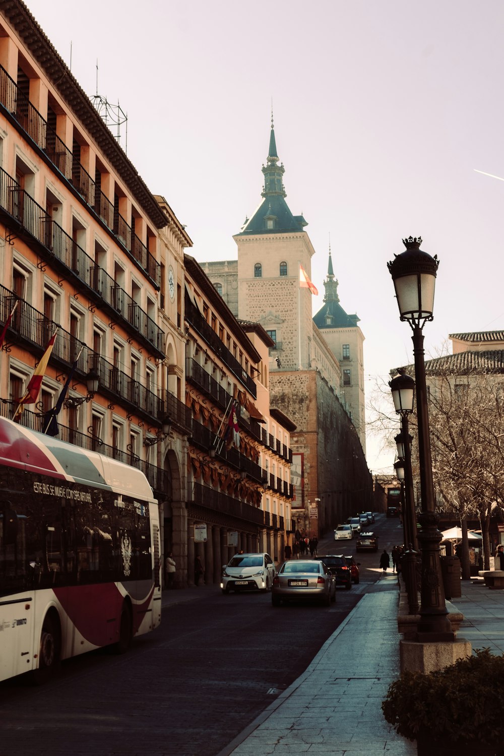 a city street filled with traffic next to tall buildings