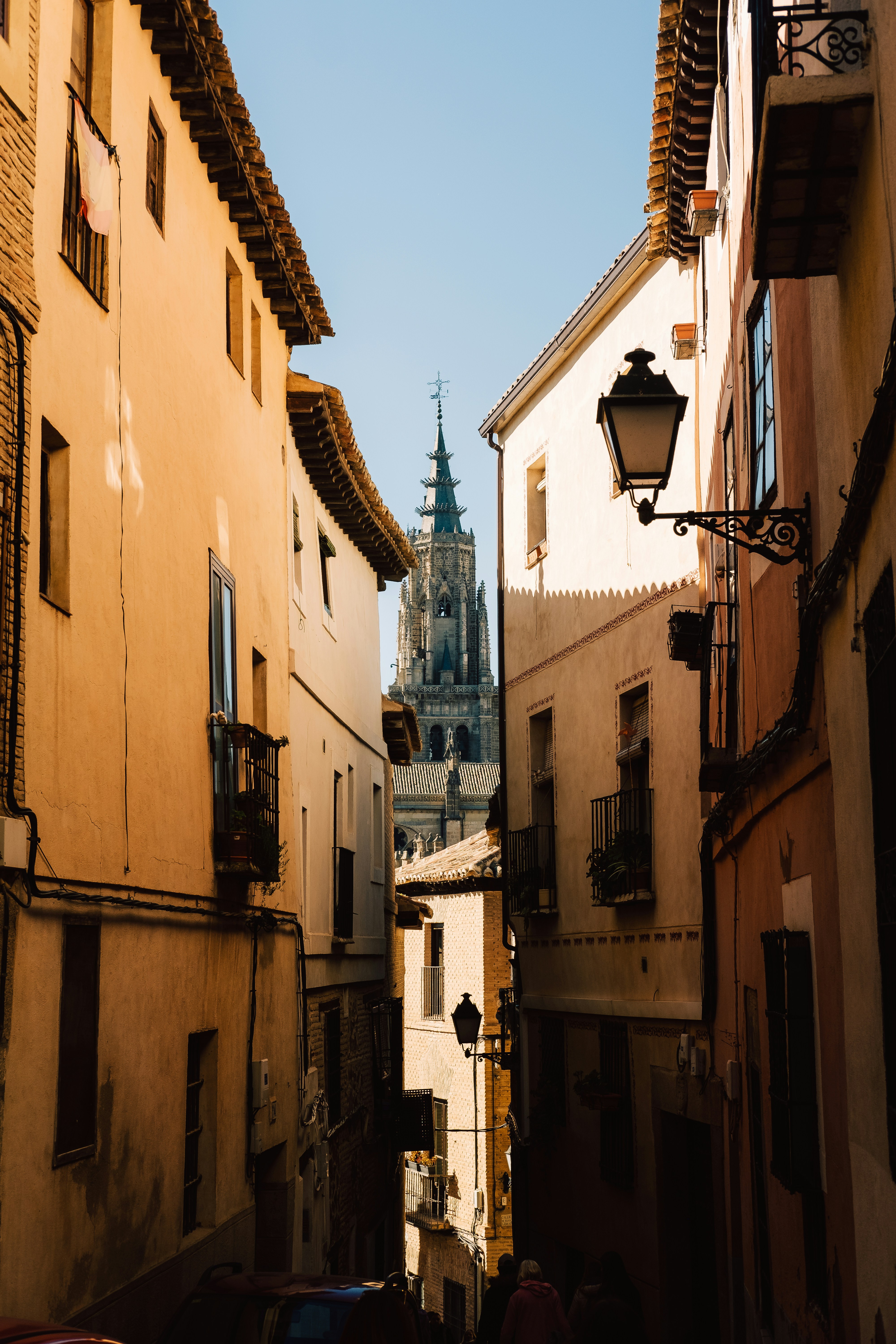 a narrow alley way with a church in the background