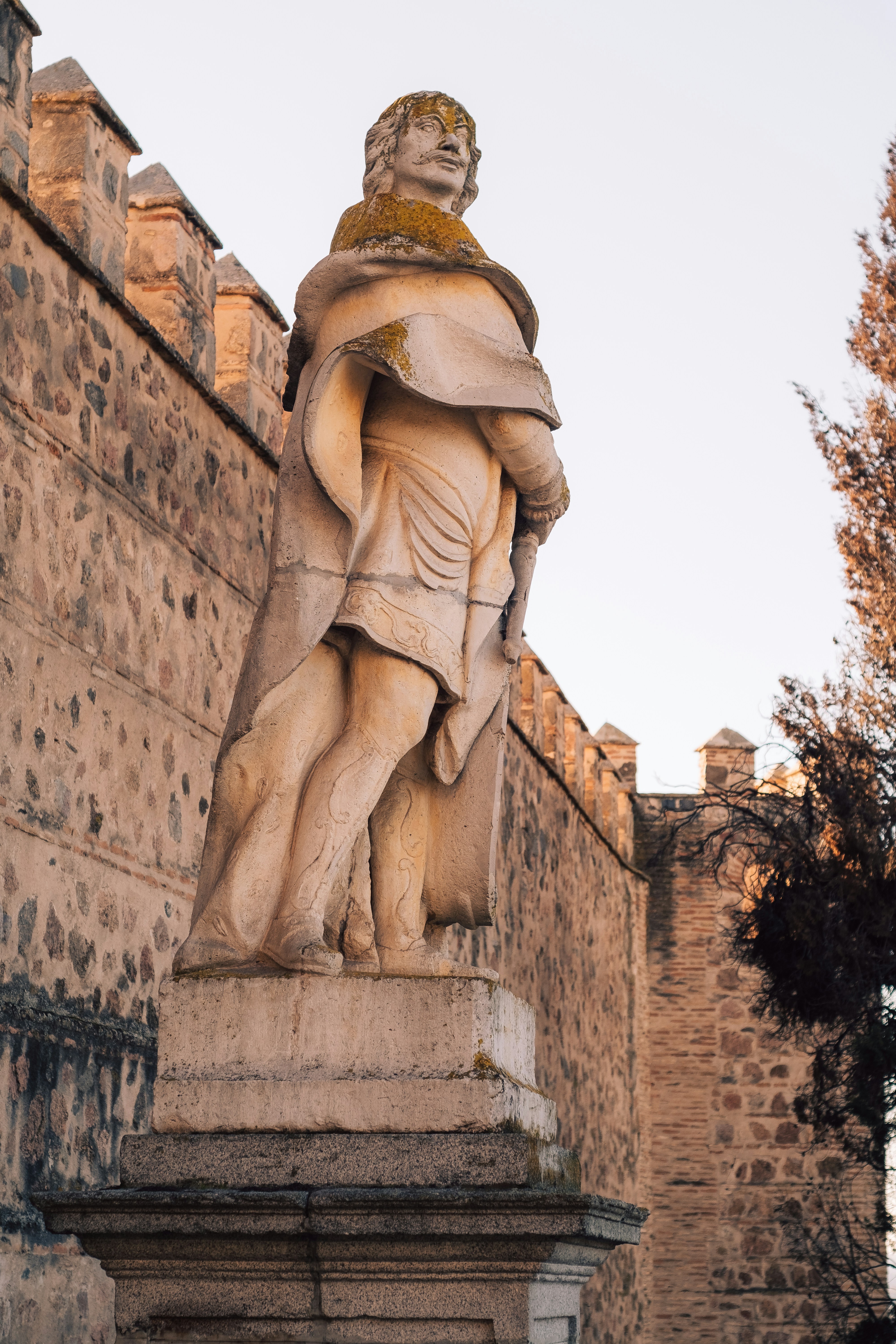 a statue of a man holding a snake