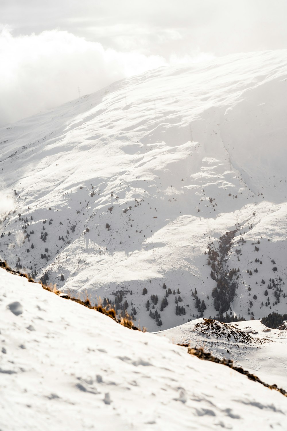 a man riding skis down the side of a snow covered slope