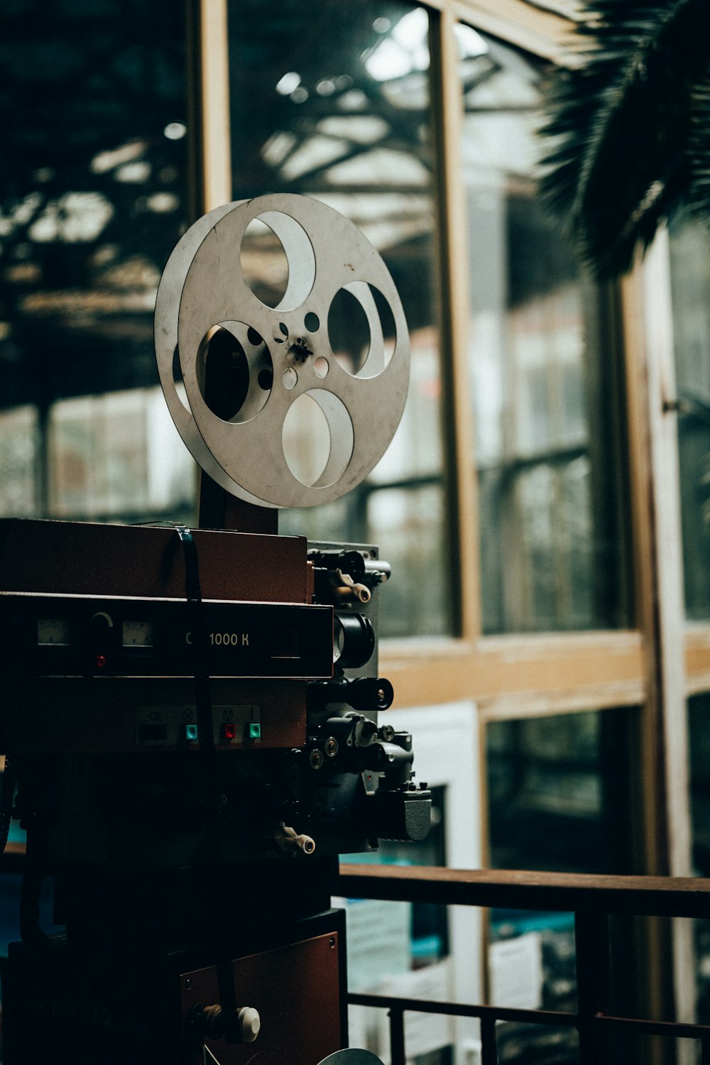 a film projector sitting in front of a window
