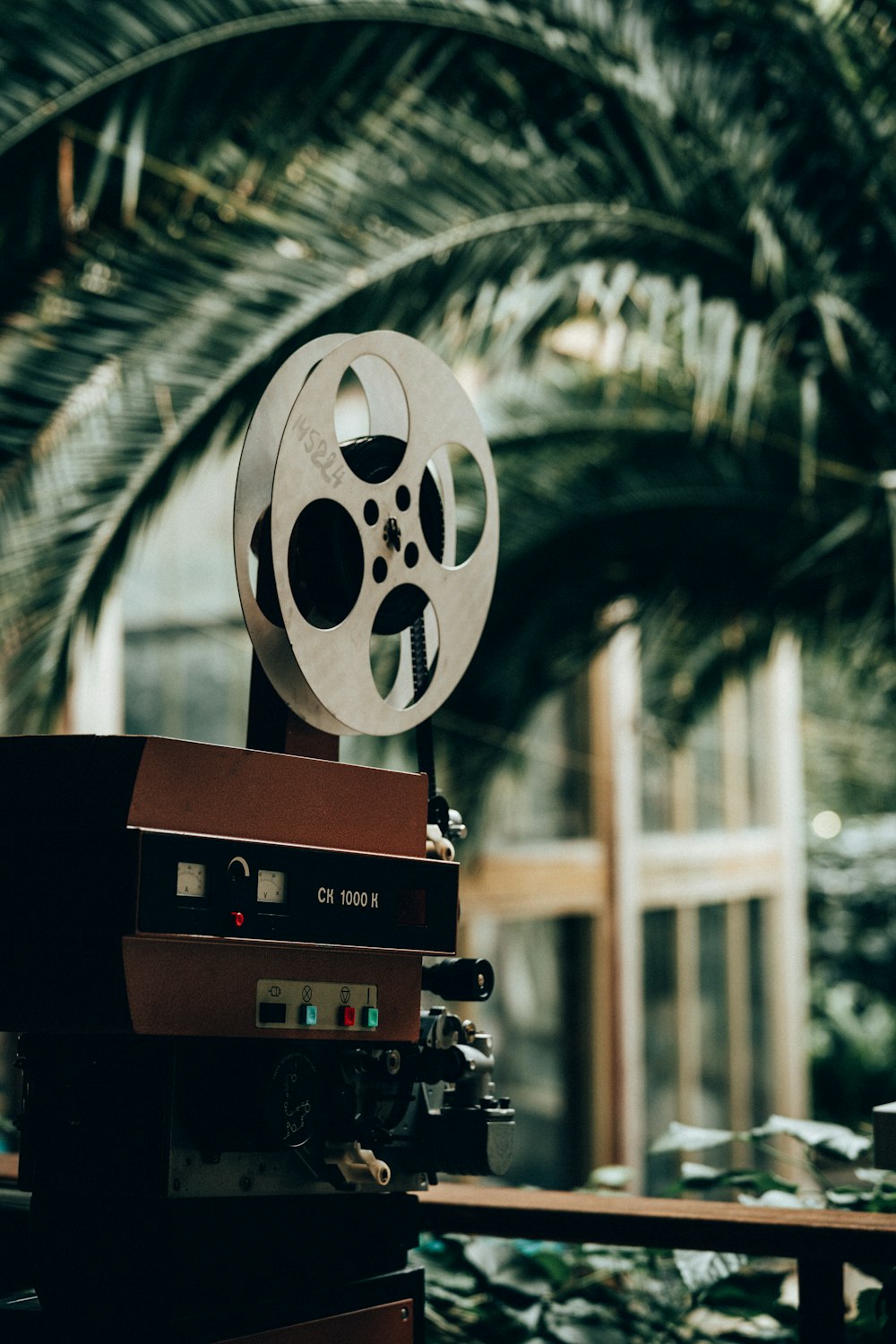 a film projector sitting on top of a wooden table