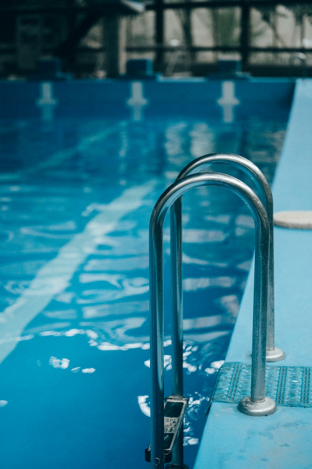 a swimming pool with a metal hand rail