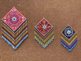 Artisan-made wall hanging combining natural fibers and beads in a rich Afrocentric style