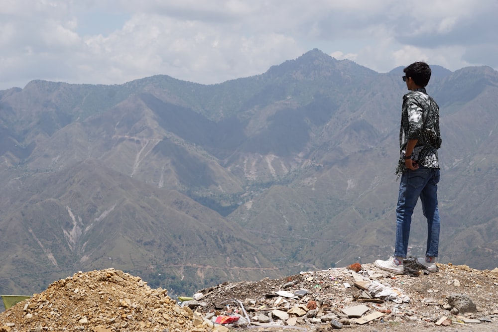 a man standing on top of a pile of rubble