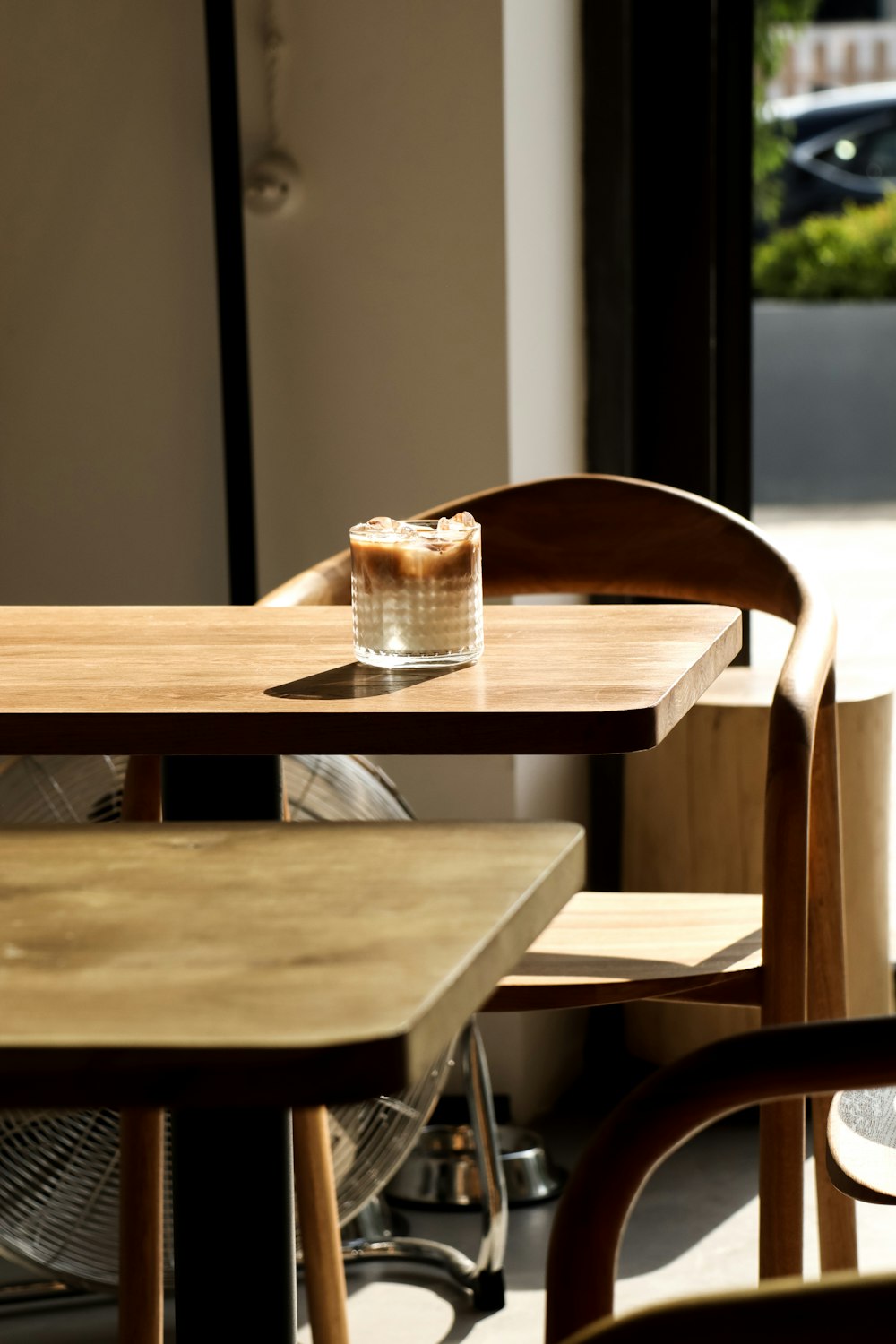 a glass of water sitting on top of a wooden table