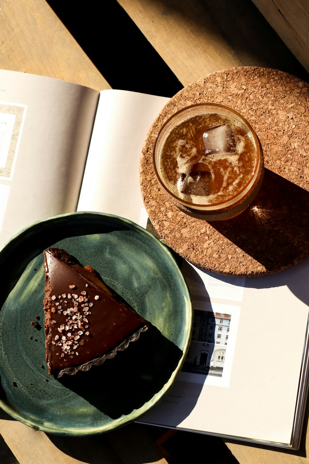 a piece of chocolate cake on a plate next to a drink