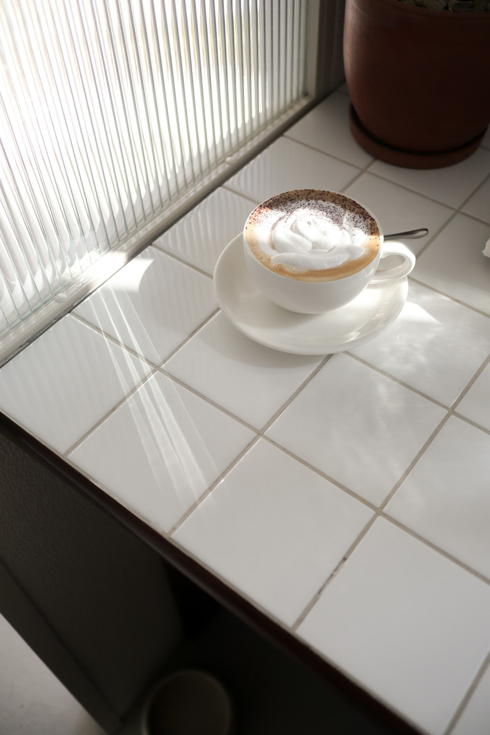 a cup of whipped cream sits on a saucer