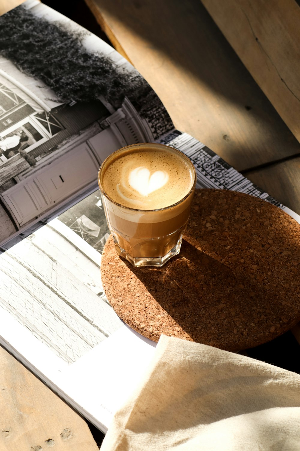 a cup of coffee sitting on top of a wooden table