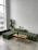 Close-up of modular metal furniture pieces arranged in a modern living room setting.