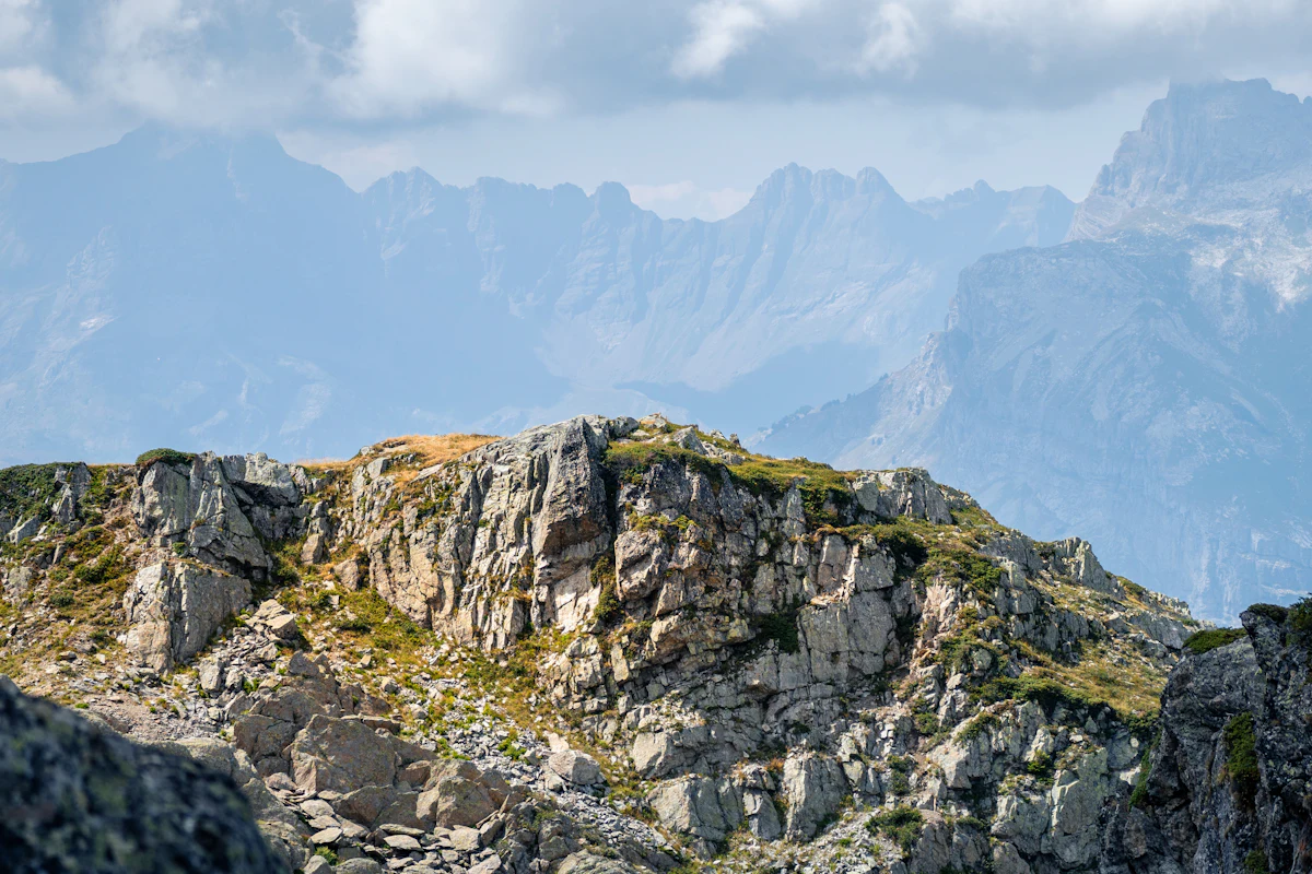 Rocky outcrops and hazy ridges seen from the top of Le Brévent