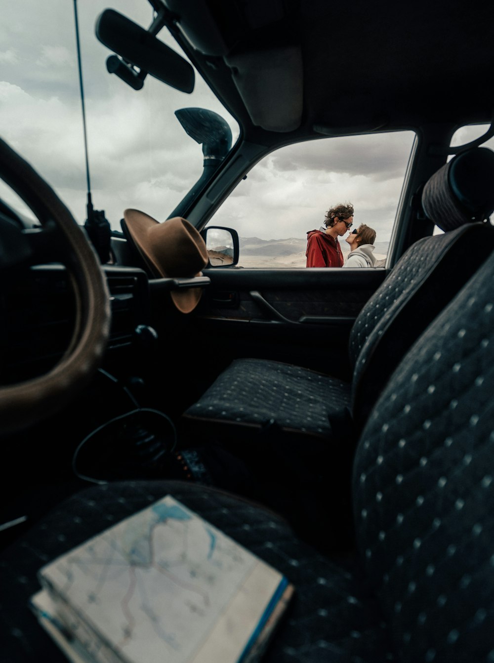 a man and woman kissing in the back of a truck