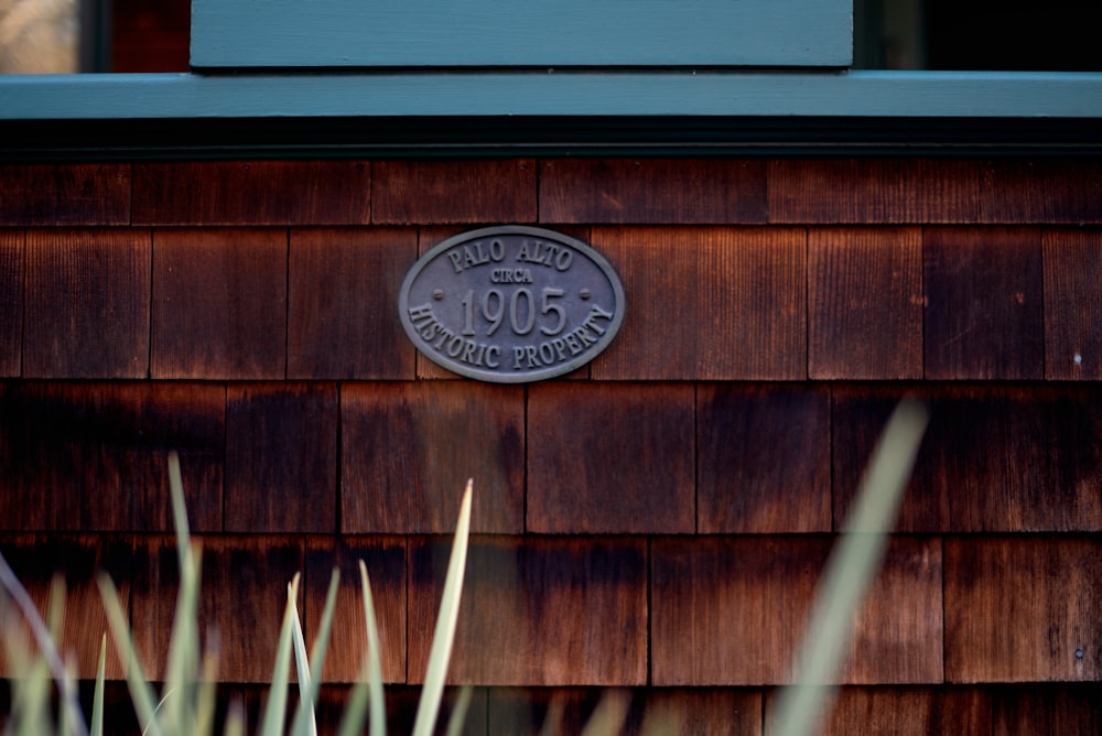 a plaque on the side of a wooden building