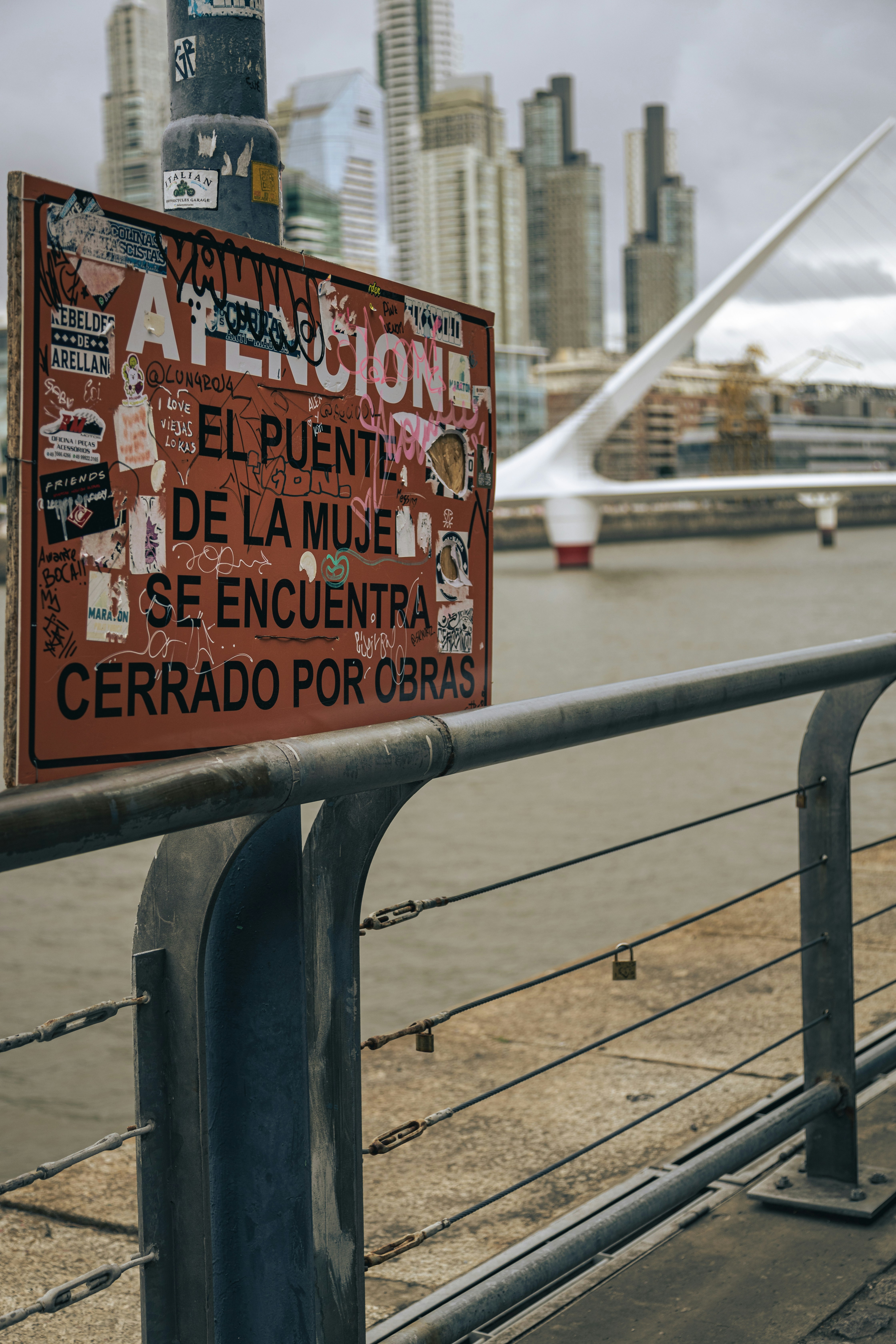a sign that is on the side of a bridge