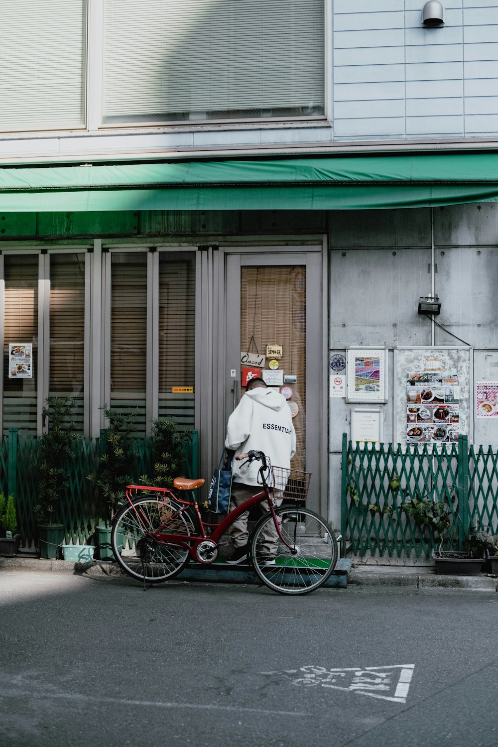 a man standing next to a bike on a street