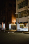 Night shot of a commercial building entrance illuminated with warm golden lighting highlighting the secure locks.