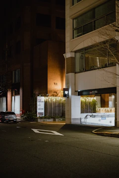 Night shot of a commercial building entrance illuminated with warm golden lighting highlighting the secure locks.