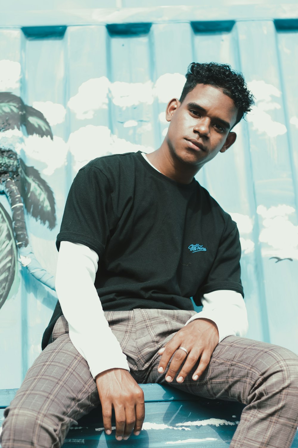 a young man sitting on top of a skateboard