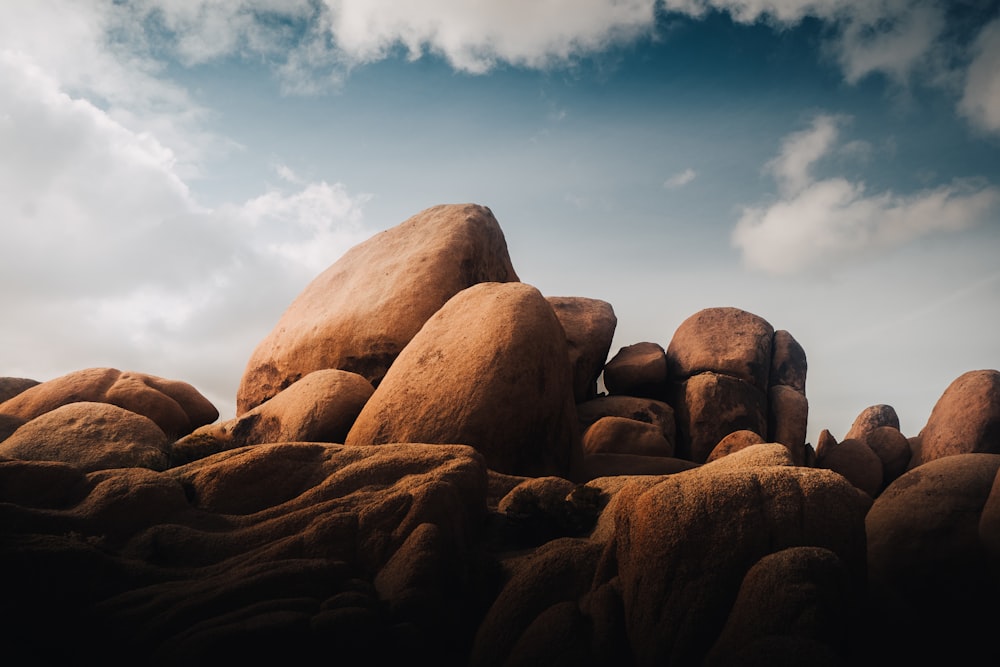 a group of rocks sitting on top of a beach