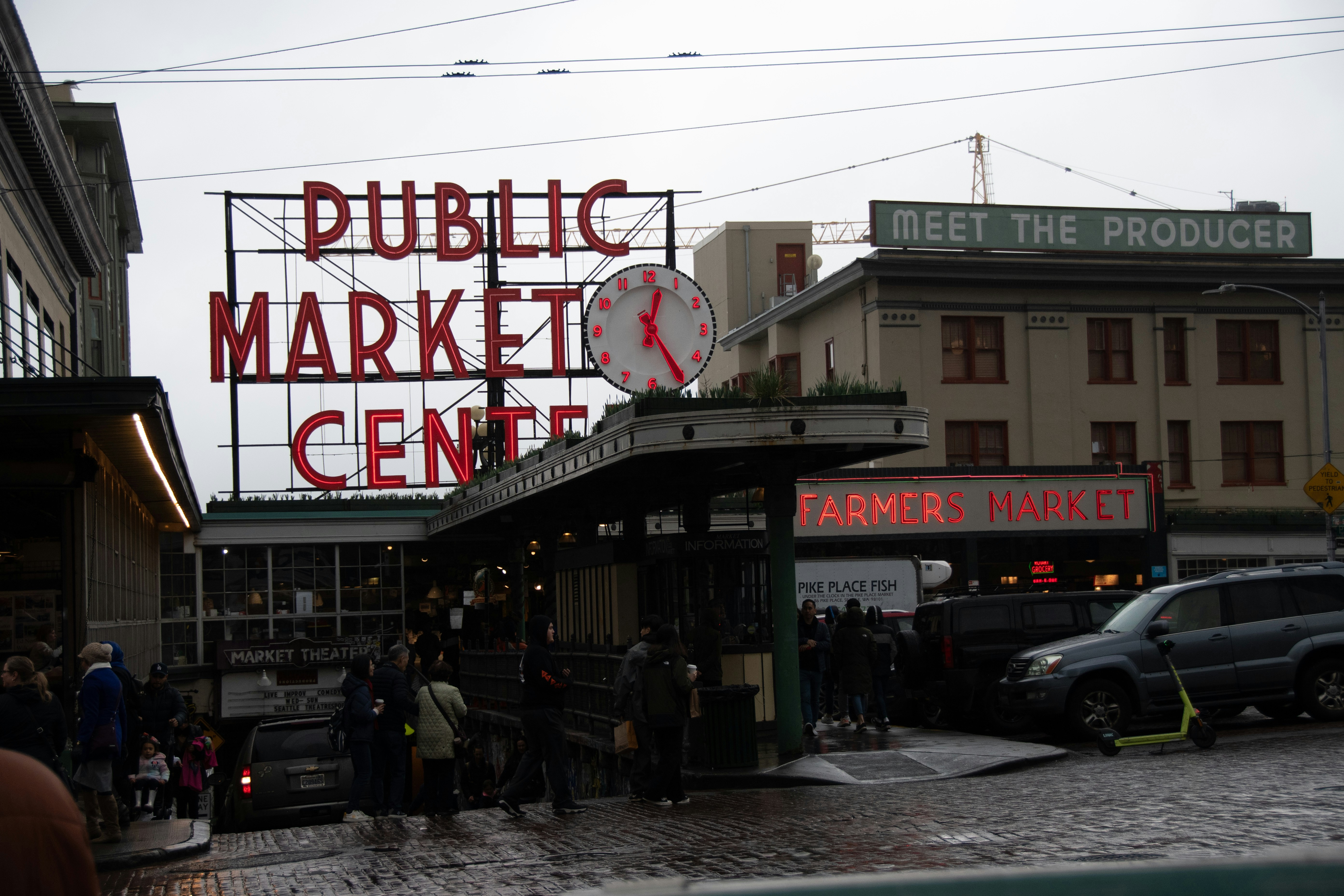 a group of people standing outside of a market
