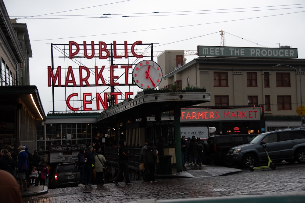 a group of people standing outside of a market