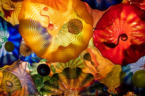 a bunch of different colored umbrellas hanging from a ceiling