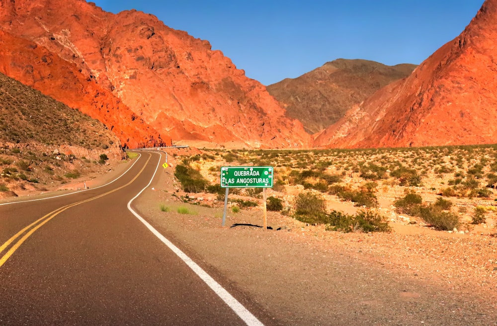 a road with a sign in the middle of it