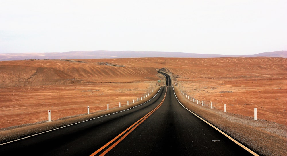 a long stretch of road in the middle of a desert