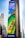 A large outdoor advertisement on a skyscraper depicts a family enjoying a water slide. The text on the advertisement reads 'Visit Orlando' and 'Anything is possible if you can imagine it.' The colors are vibrant, including a bright blue sky and a green water slide.