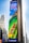 A large outdoor advertisement on a skyscraper depicts a family enjoying a water slide. The text on the advertisement reads 'Visit Orlando' and 'Anything is possible if you can imagine it.' The colors are vibrant, including a bright blue sky and a green water slide.