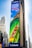 A large outdoor advertisement on a skyscraper depicts a family enjoying a water slide. The text on the advertisement reads 'Visit Orlando' and 'Anything is possible if you can imagine it.' The colors are vibrant, including a bright blue sky and a green water slide.