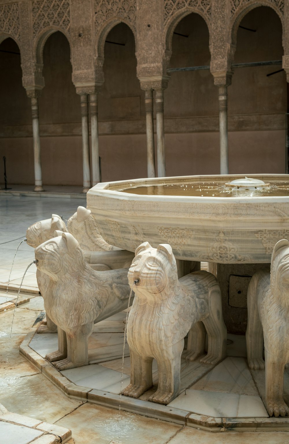 a fountain with statues of animals around it