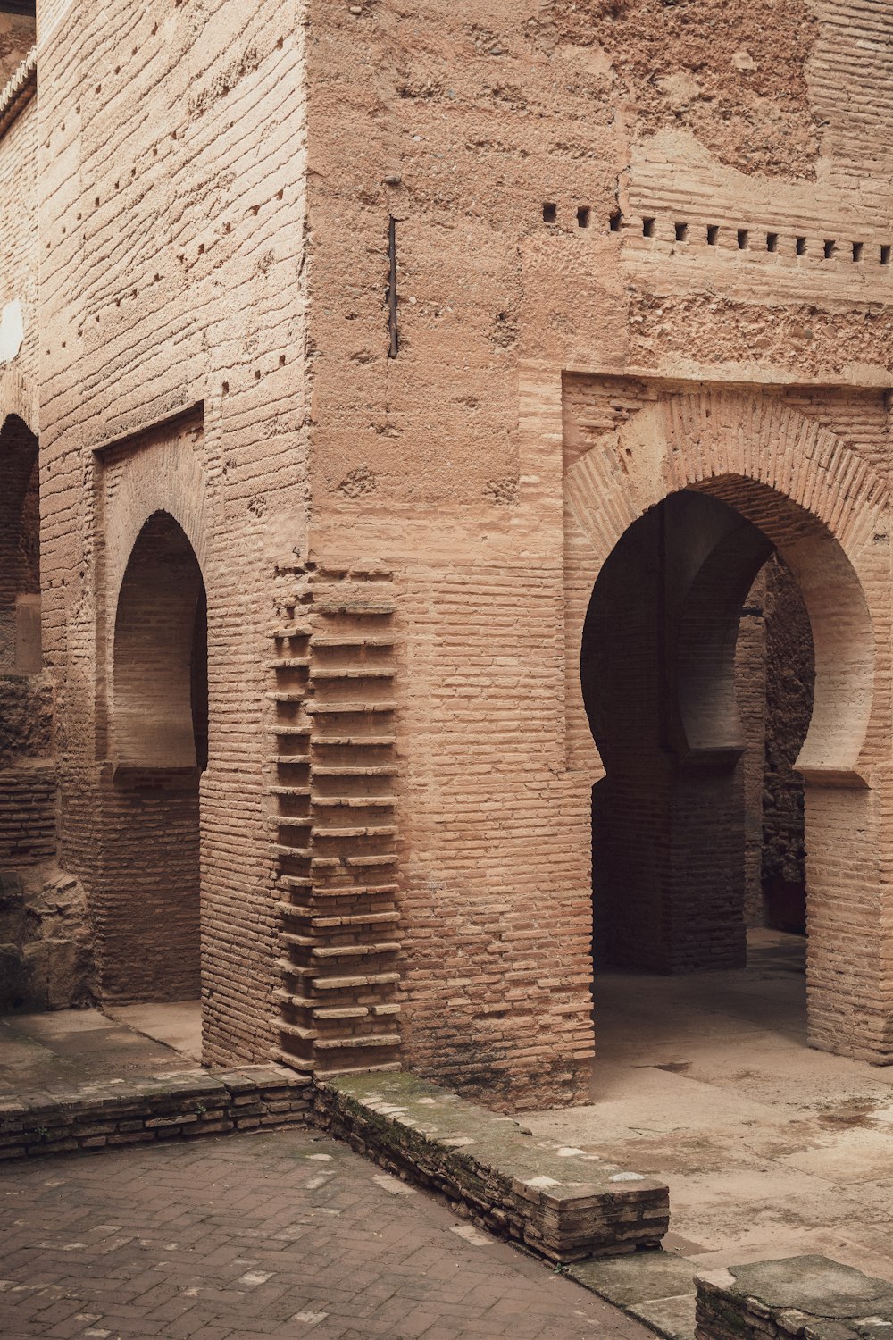 a brick building with a clock on the side of it