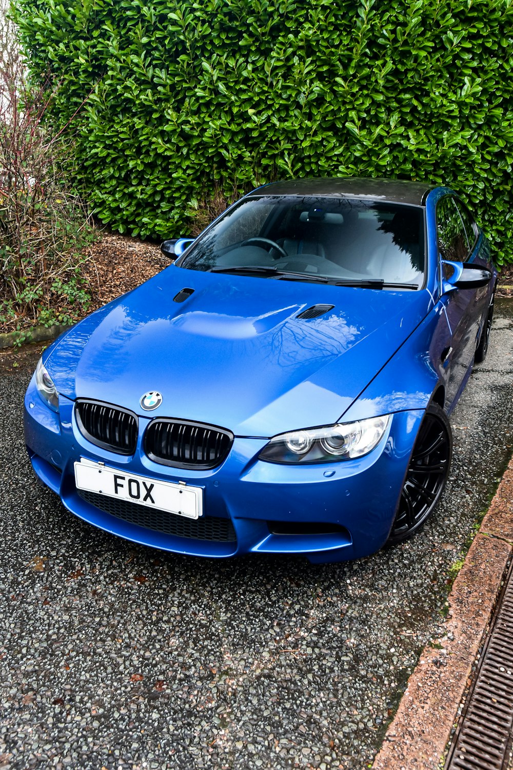 a blue car parked on the side of the road