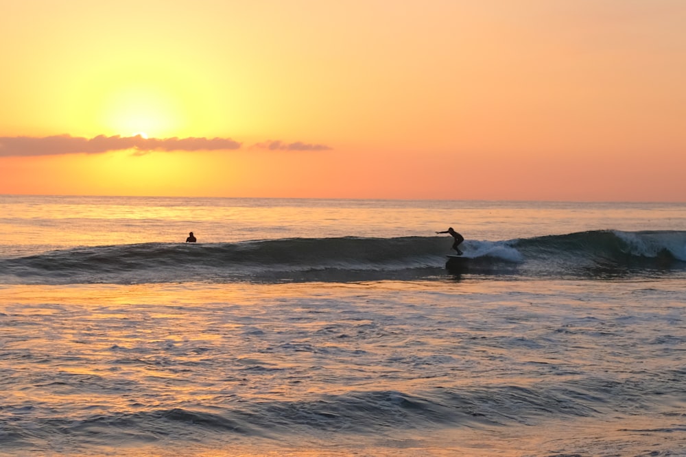 a person riding a wave on top of a surfboard