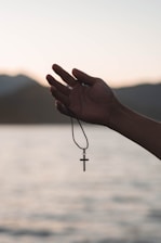 a person holding a cross in their hand