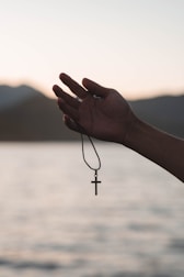 a person holding a cross in their hand