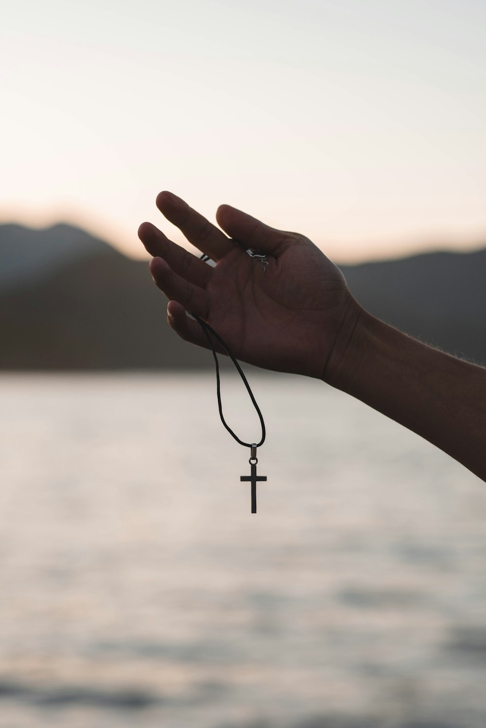 a person holding a cross in their hand