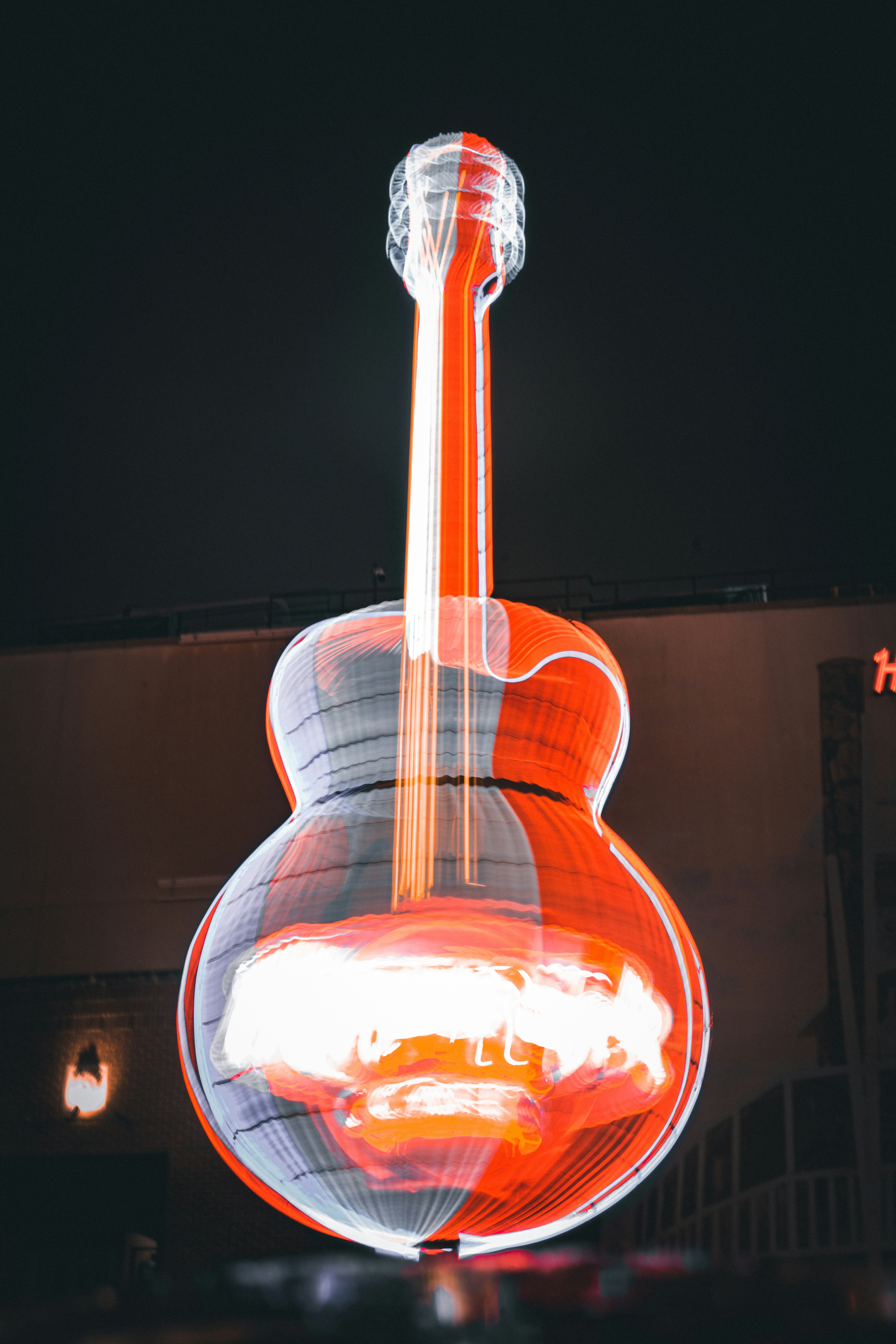 a guitar hanging from the side of a building