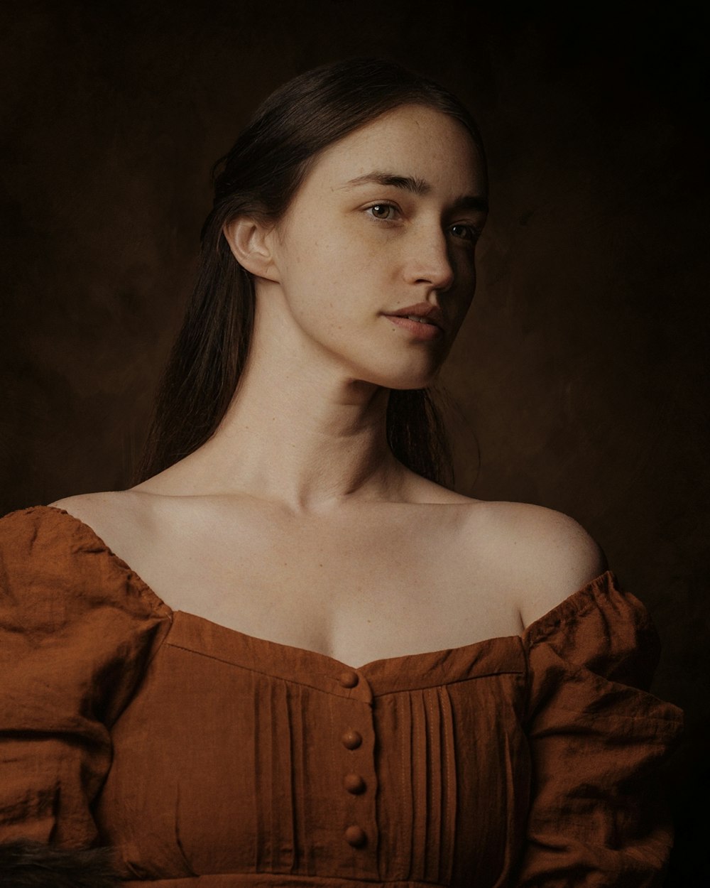 a woman in a brown dress posing for a picture