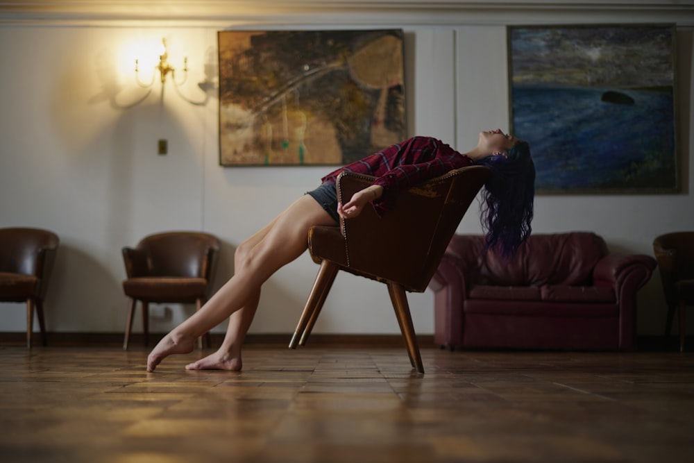 a woman sitting on a chair in a living room