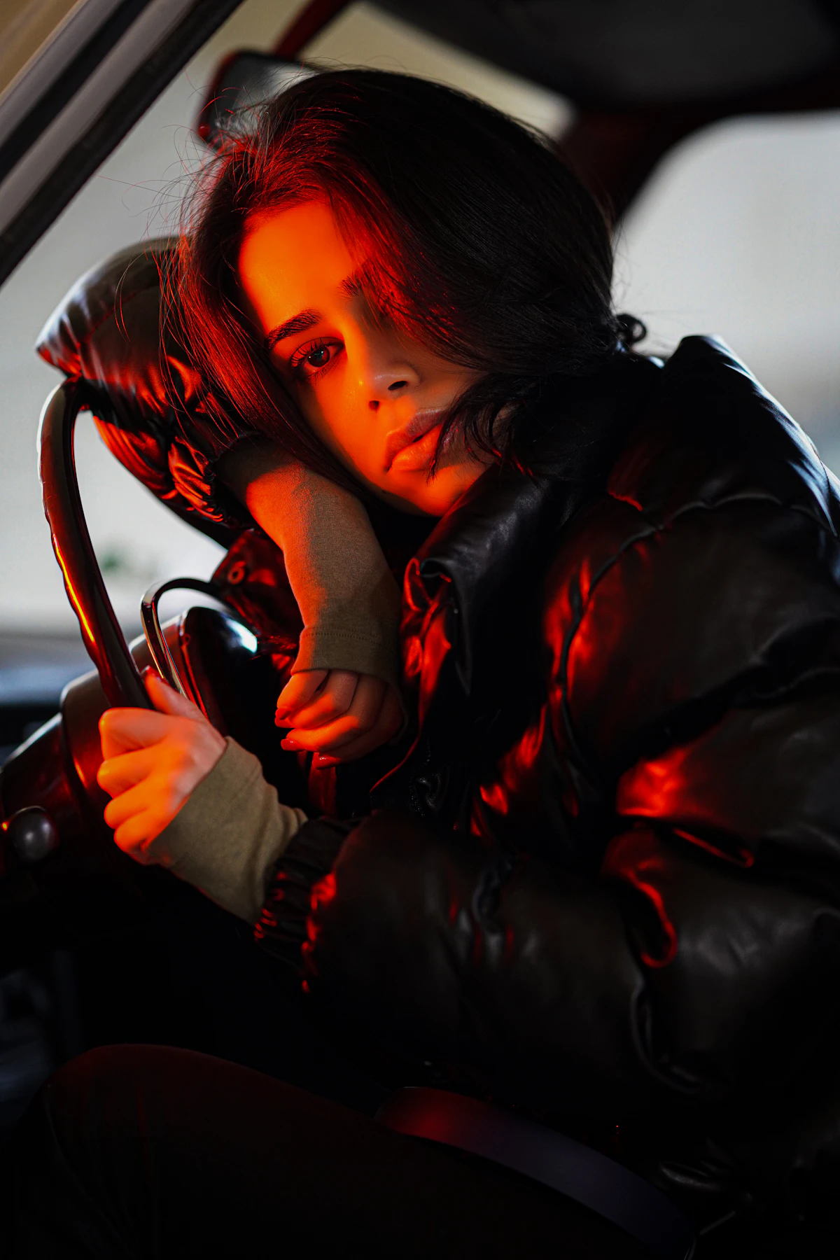 A learner smiling calmly behind the steering wheel
