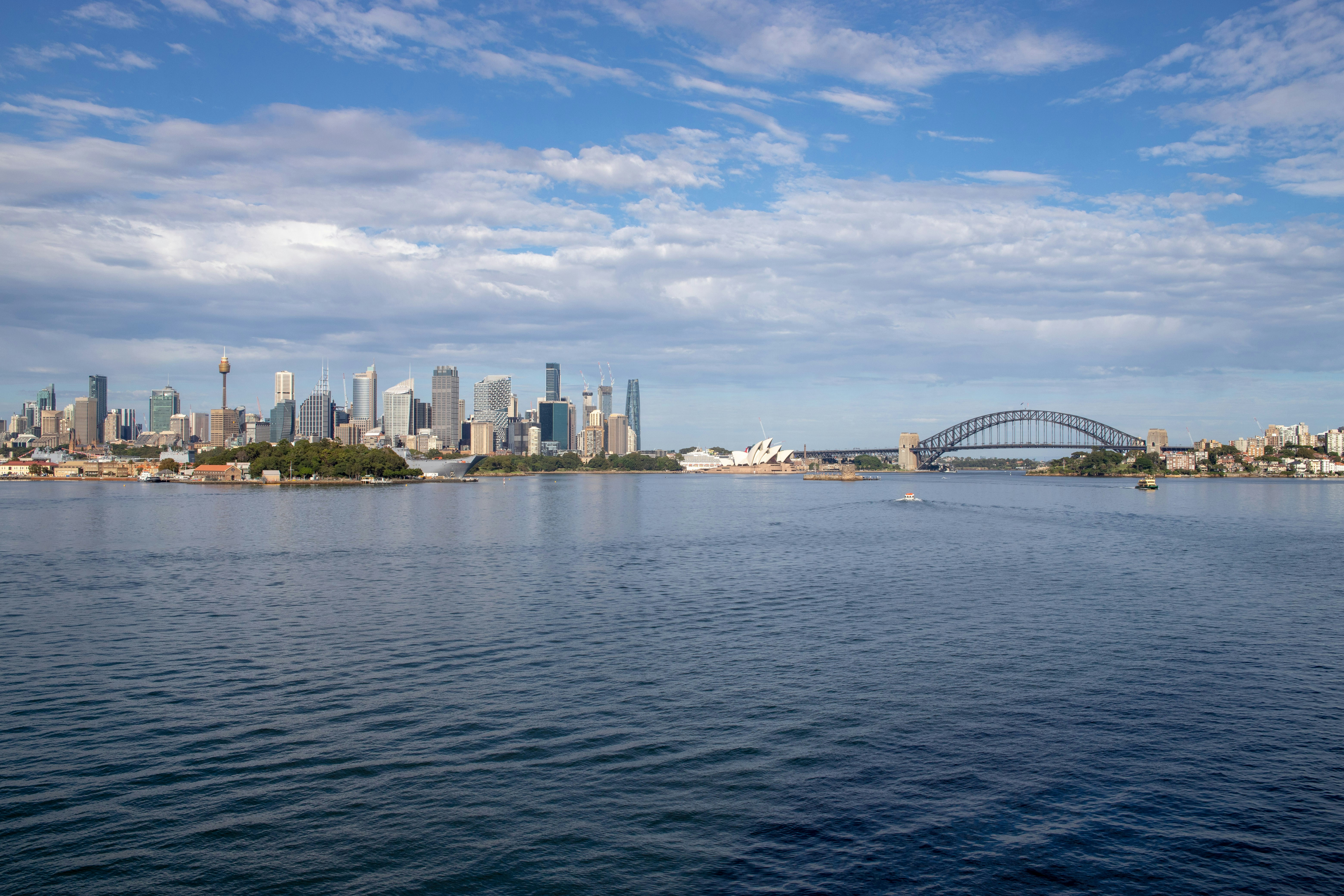 a large body of water with a city in the background