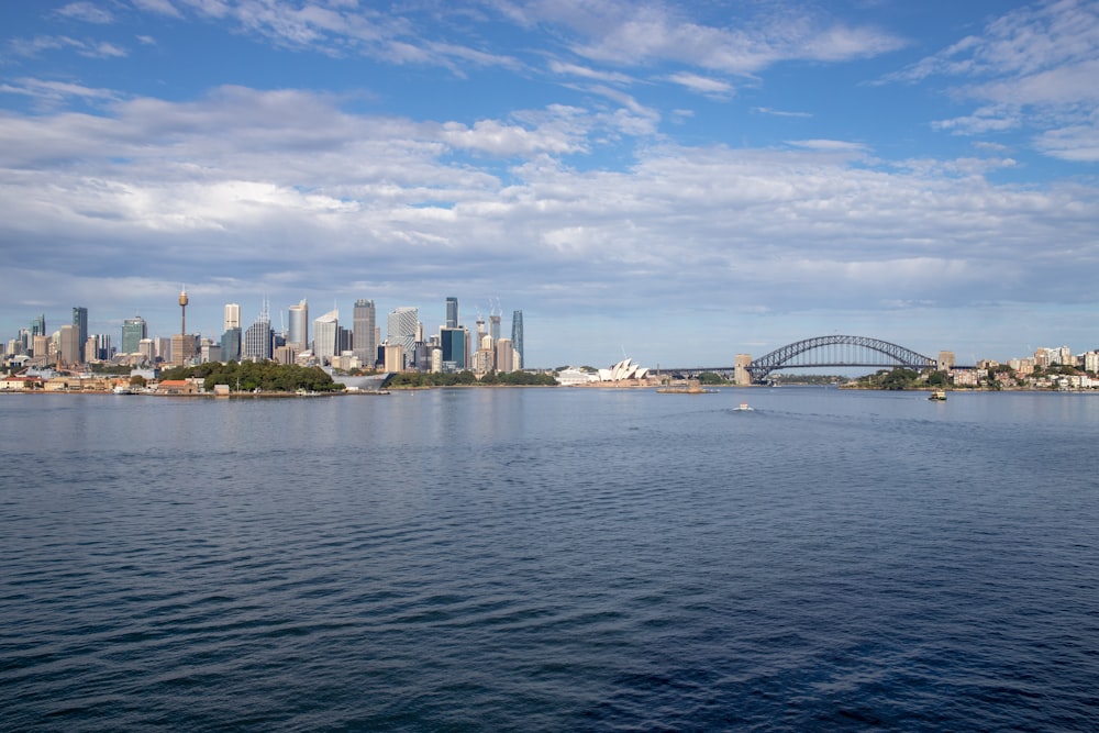 a large body of water with a city in the background